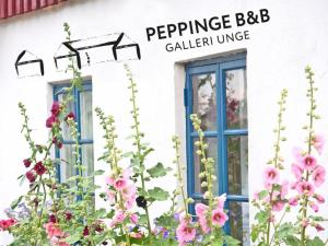 a building with flowers in front of a window at Peppinge Bed & Breakfast in Löderup