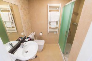 a bathroom with a sink and a toilet and a shower at Chrielka Hotel in Limassol