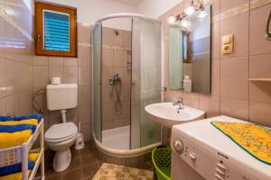 a bathroom with a shower and a toilet and a sink at JELICIC C in Crikvenica +16 photos