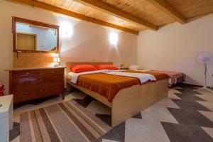 a bedroom with a bed and a dresser and a mirror at JELICIC C in Crikvenica