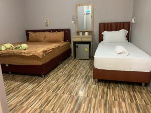 Postel nebo postele na pokoji v ubytování Green House Resort Praduyuen