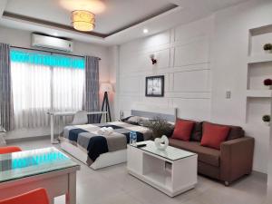 a living room with a bed and a couch at Eco SaiGon Apartments in Ho Chi Minh City