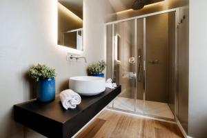 a bathroom with a sink and a shower at AMA 18 Rooms - The House Of Travelers- in Como