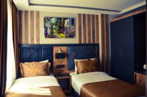Кровать или кровати в номере RUA WORLD HOTEL