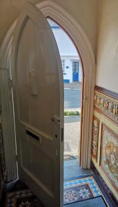 an archway leading to a door in a room at Durham House in Beer