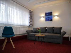 a living room with a couch and a table at Wochner's Hotel-Sternen Am Schluchsee Hochschwarzwald in Schluchsee