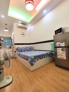 a bedroom with a bed and a fan in it at Saigon Apartments 2 in Ho Chi Minh City