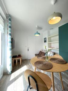 a living room with two tables and a couch at STUDIO, UN HAVRE DE PAIX - BIDART ERRETEGIA in Bidart