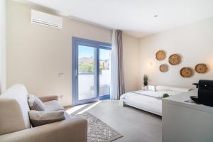 a white bedroom with a bed and a window at Enjoy Your Stay - Guest House - Olbia in Olbia