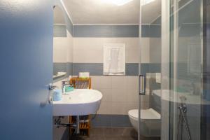 a bathroom with a sink and a toilet and a shower at Ludovica Flat in Vernazza