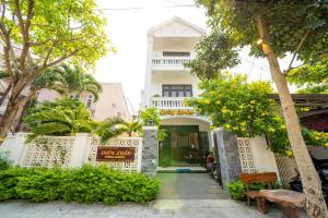 a building with a sign in front of it at Spring Garden Villa Hoi An in Hoi An