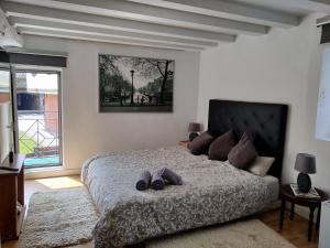 a bedroom with a bed with two shoes on it at Amets house in Bilbao
