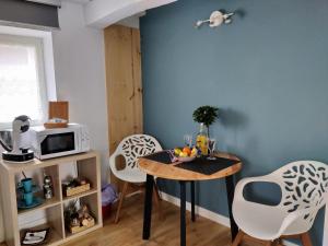 a kitchen with a table and chairs in a room at Amets house in Bilbao