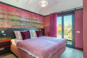 a bedroom with a large bed and a large window at DRL45 Luxury apartment in the heart of Domburg in Domburg