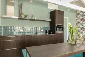 cocina con armarios de madera y encimera en DRL45 Luxury apartment in the heart of Domburg, en Domburg