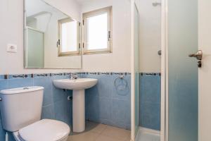 łazienka z toaletą, umywalką i lustrem w obiekcie Apartamentos Hipocampos Unitursa w mieście Calpe