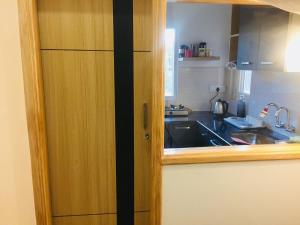 a kitchen with a sink and a wooden cabinet at Siddharth BnB - Near Golden Temple in Amritsar