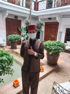 a man wearing a face mask in a building at Riad Les Nuits de Marrakech in Marrakesh