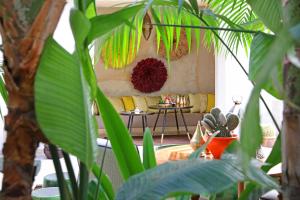 a living room with a couch and some plants at Dar Kandi in Marrakech