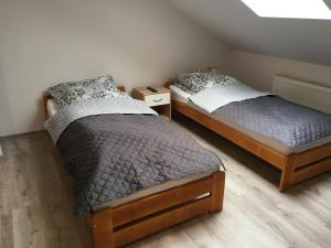 two twin beds in a room with at VOTIVI in Sanok