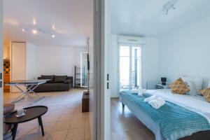 a bedroom with a large bed and a living room at The Aviator in Bussy-Saint-Georges