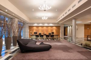 a large lobby with a black couch in the middle at Eurostars Valbusenda Hotel Bodega & Spa in Toro