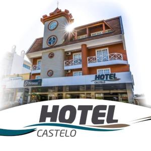 a hotel with a sign in front of it at Hotel Castelo in Gravatal