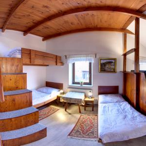 a room with two bunk beds and a table at Penzion U Lesa in České Budějovice