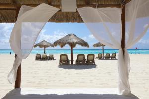 a view of a beach with chairs and umbrellas at Emporio Cancun - Buy All Inclusive Option in Cancún