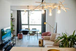 a living room with a couch and a table at Onix 75 in Mamaia Sat/Năvodari