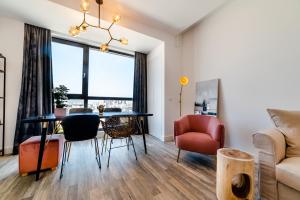 a living room with a table and chairs at Onix 75 in Mamaia Sat/Năvodari