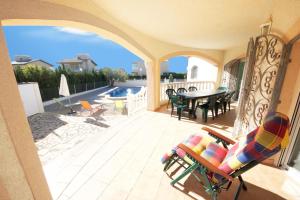 a balcony with a patio with a table and chairs at Villa Nicole in L'Ampolla