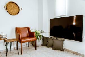 A television and/or entertainment centre at Chania Paradise Retreat - Falasarna Villa Nostalgia