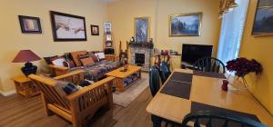 a living room with a couch and a fireplace at Vacation Homes by The Bulldog- Berker's Suite A in Silver Star