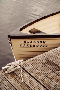 a boat sitting on a dock next to the water at Glasson LakeHouse in Athlone