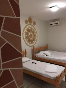 a room with two beds and a wall at Pousada Serra Negra in Bezerros +16 photos