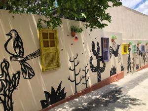 a wall with a painting on the side of a building at Pousada Serra Negra in Bezerros