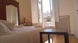 Postel nebo postele na pokoji v ubytování B&B I sei volti Lecce