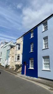 a blue and white building on the side of a street at Little Monmouth 4 bedroom cottage, Old town Lyme Regis, dog friendly and parking in Lyme Regis
