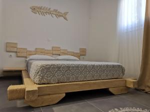 a bedroom with a bed on a wooden platform at Family Villages Santorini in Vlychada Beach