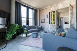 a living room with blue furniture and a large window at Port of Travemünde, Opening 2021 in Travemünde