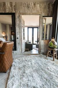 a living room with a large rug on the floor at Port of Travemünde, Opening 2021 in Travemünde