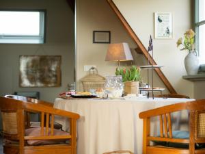 - une table à manger avec un chiffon blanc dans l'établissement Landgoed het Heuvelbosch, à Waardenburg