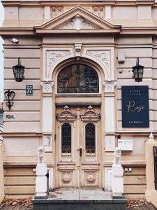 a building with a door with a sign on it at Roze Villa in Liepāja