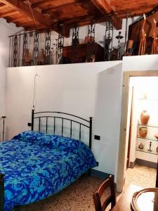 a bedroom with a bed with a blue comforter at Casa La Fornace in Fornacette