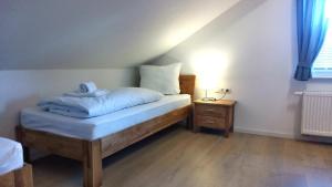 a bedroom with a bed and a night stand with a lamp at FeWo "Im Städt´le" Immenstadt in Immenstadt im Allgäu