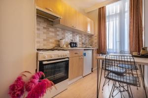 a kitchen with a stove and a counter with a table at MARİA House in Antalya