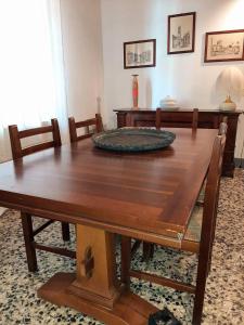a wooden dining room table with chairs and a table at Casa La Fornace in Fornacette