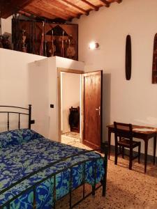 a bedroom with a bed and a desk and a table at Casa La Fornace in Fornacette
