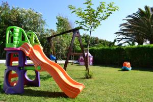 a playground with a slide on the grass at Alonaki Beach in Preveza